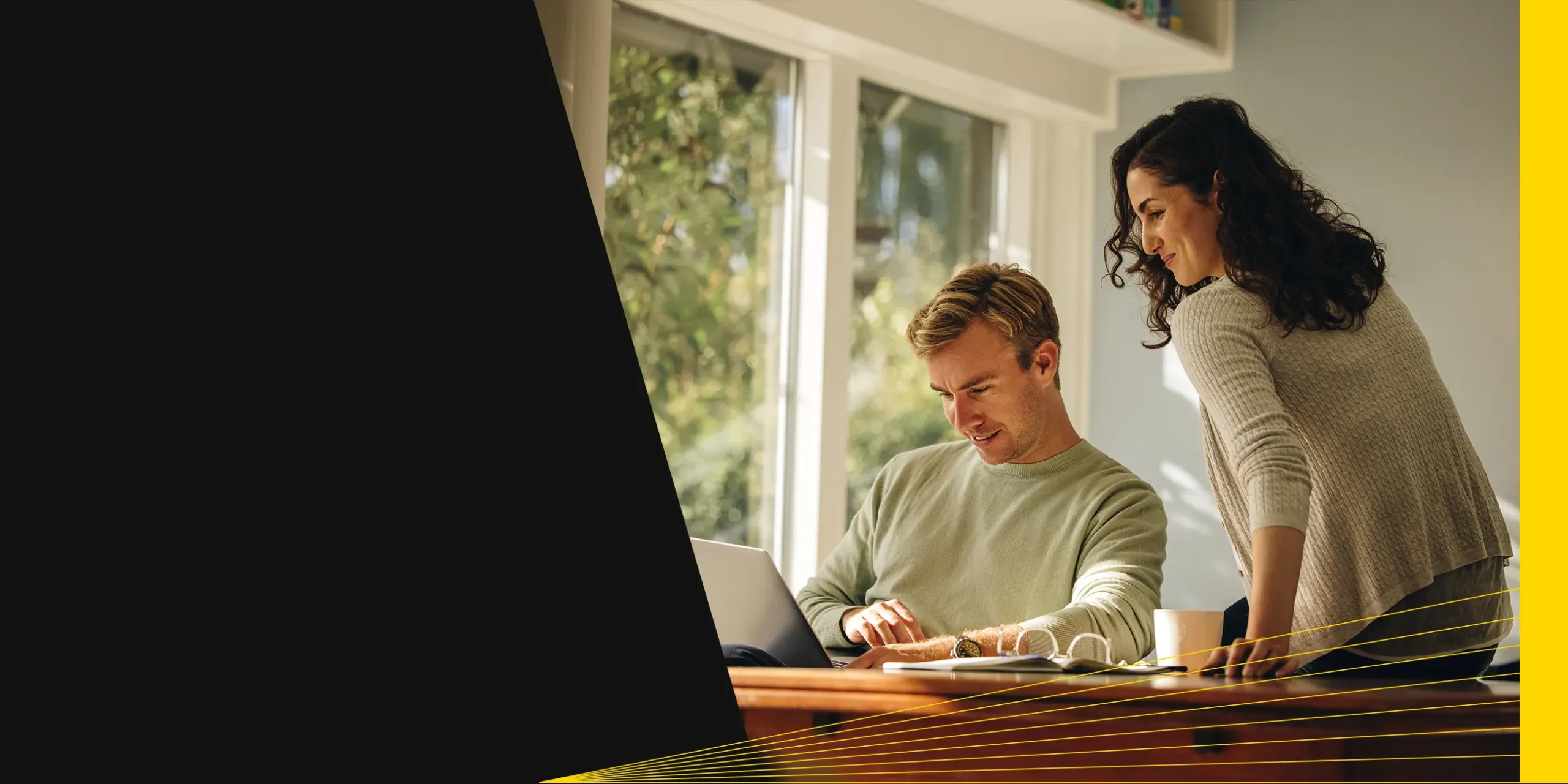 Young couple reviewing a financial plan on a laptop to start retirement planning and creating a comprehensive financial strategy.