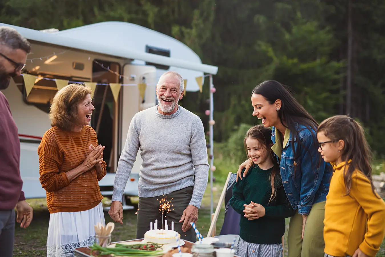 Multi-generational family gathering outdoors.