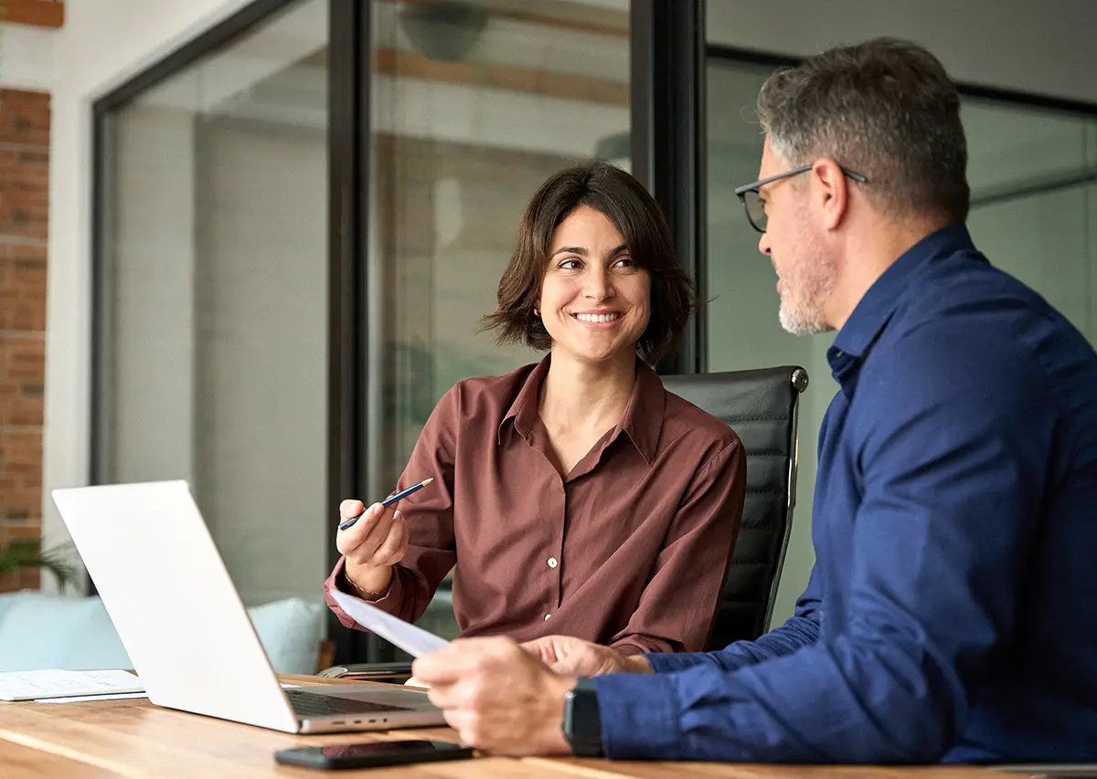 Young female financial advisor speaking with client at a laptop about their financial planning with Solas Wealth Strategies.
