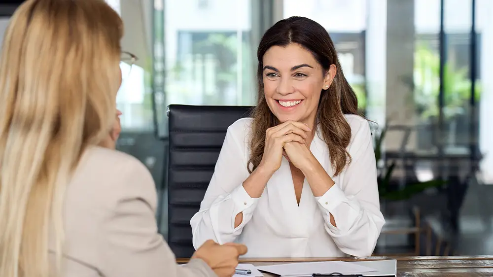 Young caucasian female financial advisor listening to her client.
