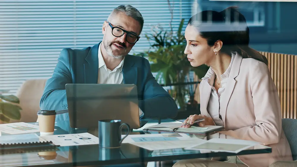Wealth management professionals reviewing financial information together.