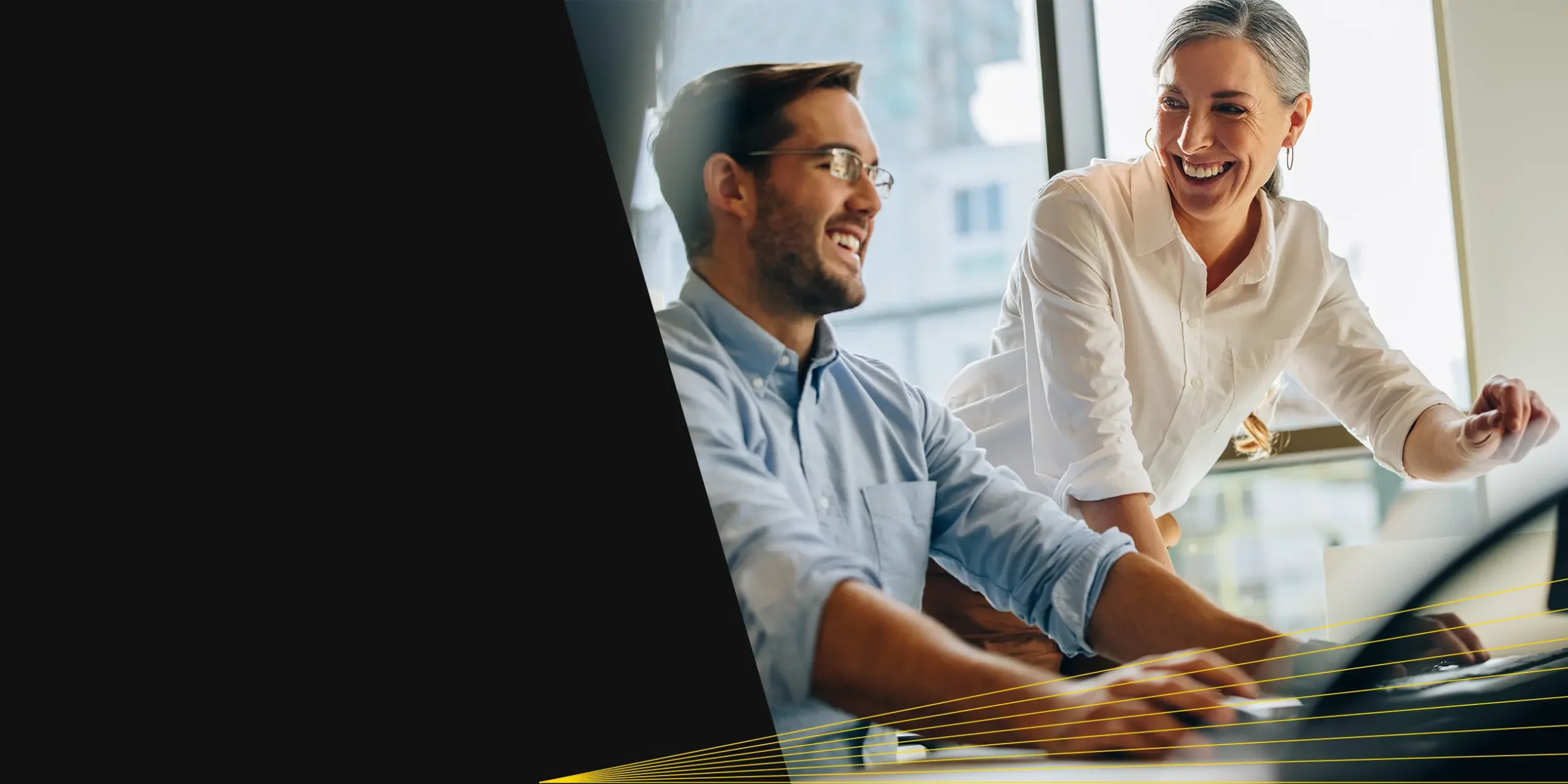 Two professionals collaborating over a laptop on comprehensive wealth planning and investment guidance.