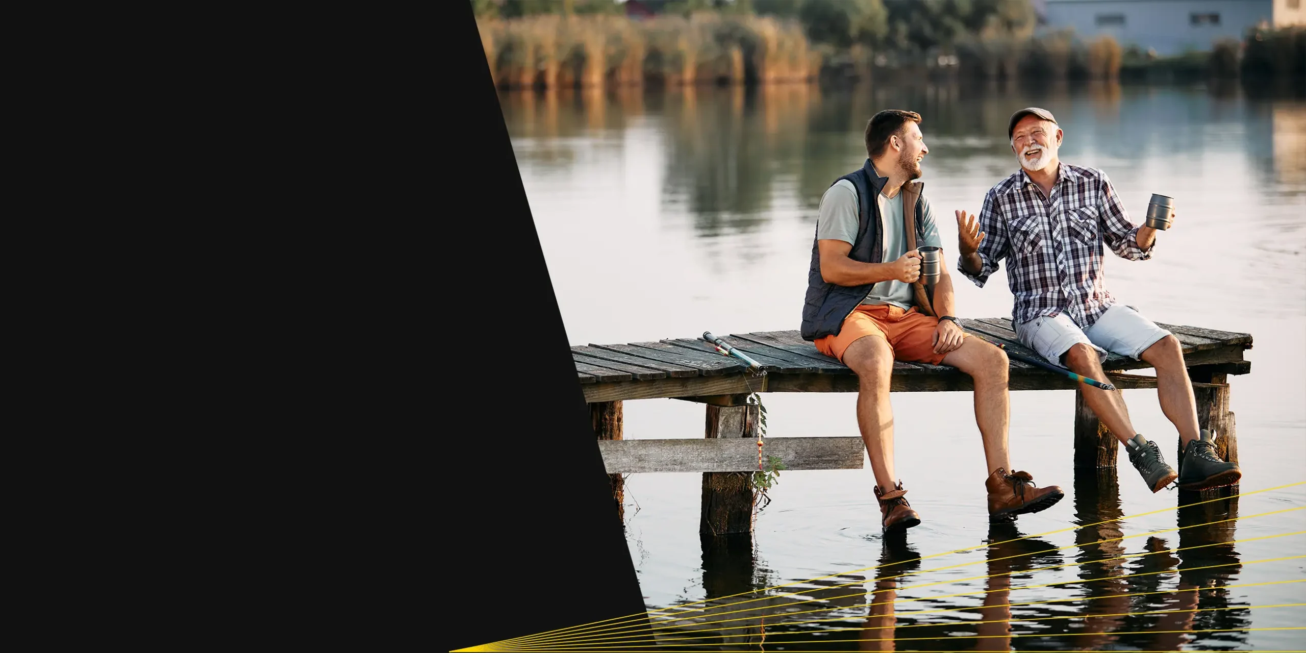 Caucasian father and adult son relaxing on a dock by the water.